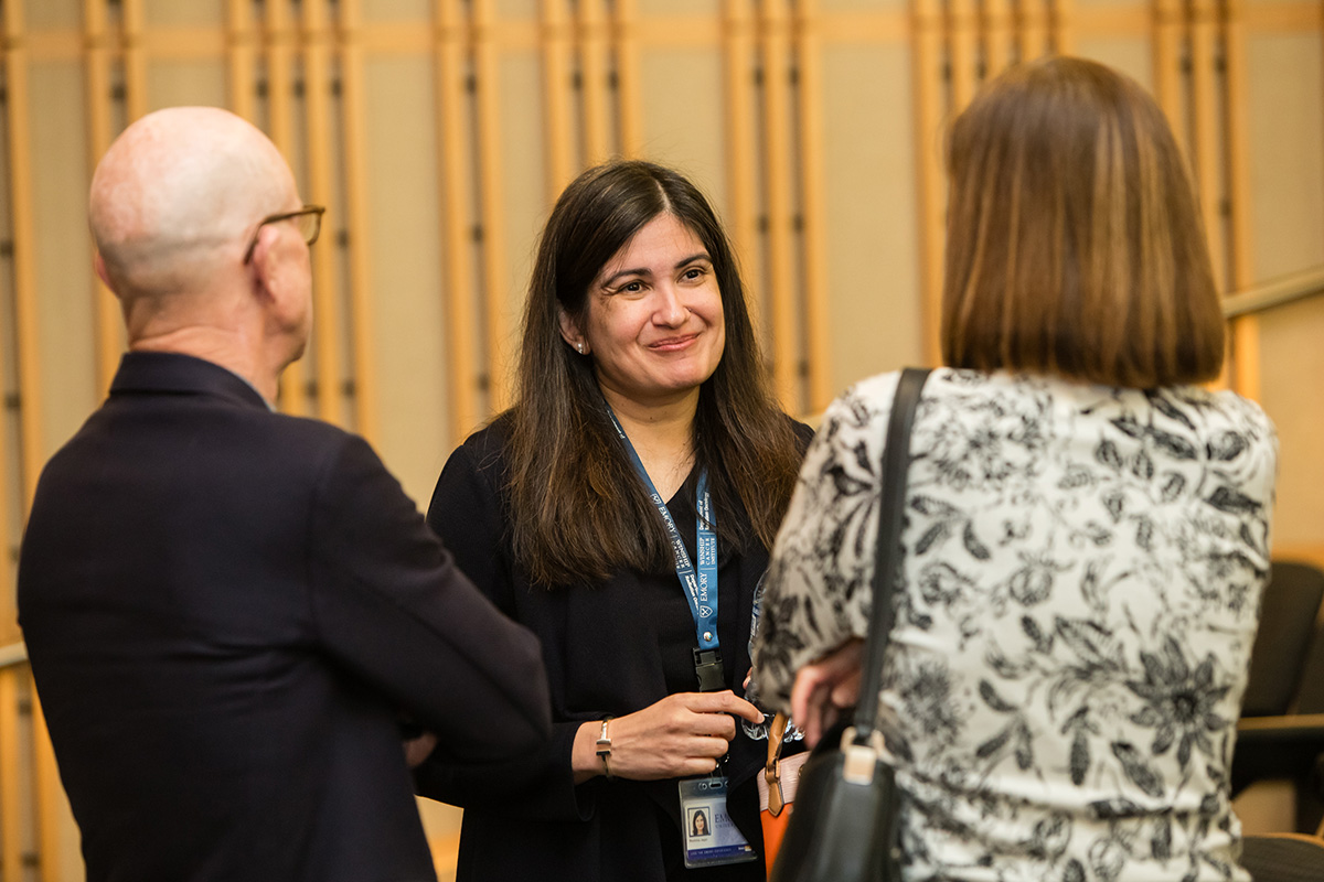 Keynote speaker Reshma Jagsi, MD, DPhil, chats with two summit attendees